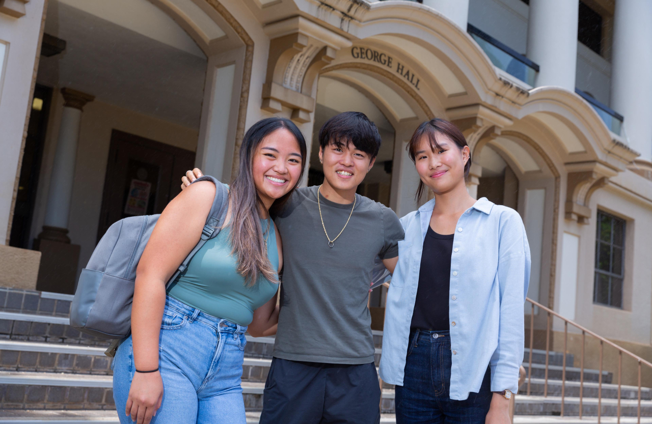 TIM students posing in front of George Hall. 