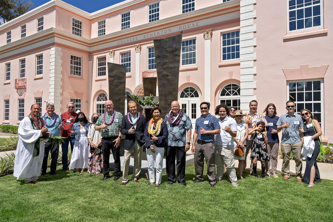 Stakeholders and subjects of this article stand in front of the sculpture in question.