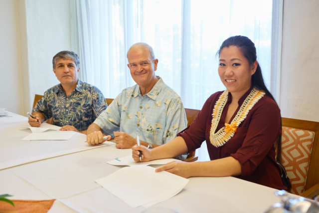 AFWA signing with Dean Vance Roley and School of Accountancy Director Hamid Pourjalali