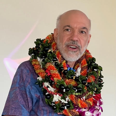 Professor Emeritus William Chismar with a lot of leis at his retirement party.