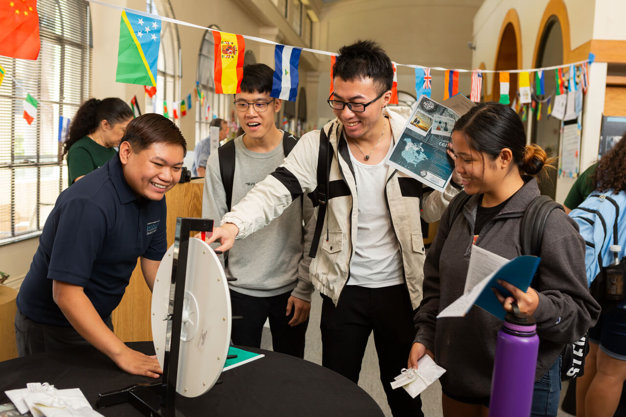 A group of students play a game at the study abroad fair.